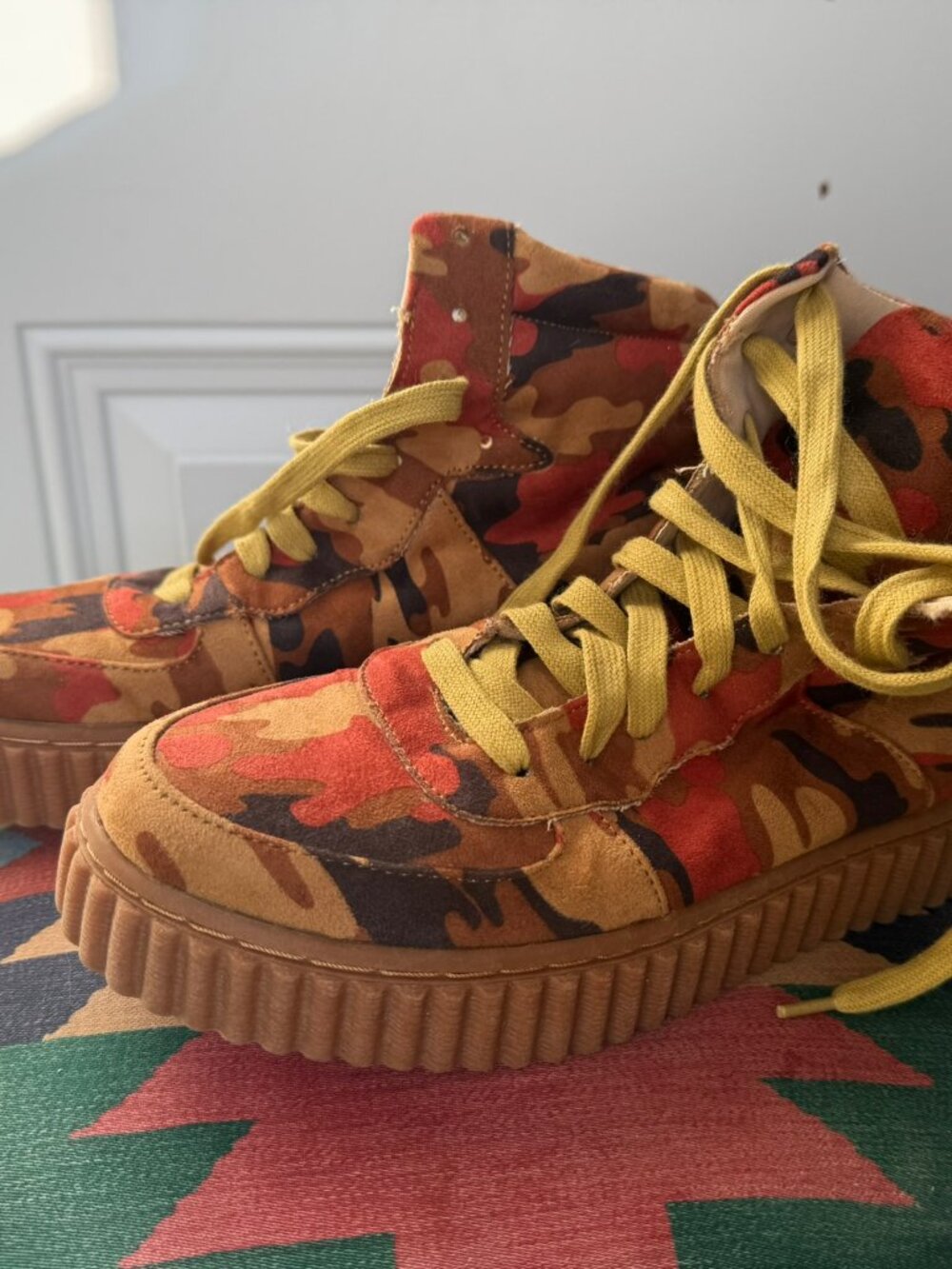 Olivia Ferguson orange camo high tops